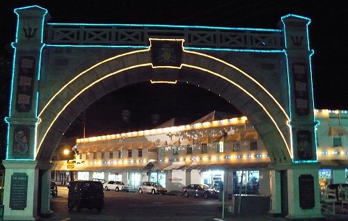 Independence Arch lit at night in the national colours