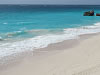 A secluded white sand beach located on the south-east coast with ruins of an old mansion on the clifftop overlooking the beach.